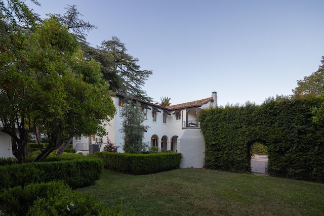 205 S Lomita Ave, Ojai, CA 93023 - view of home's exterior featuring a chimney, a yard, stucco siding, and a balcony