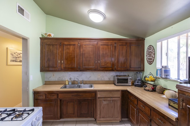 3608 Via Orilla, Lompoc, CA 93436 - kitchen with vaulted ceiling, light countertops, white range with gas stovetop, and decorative backsplash