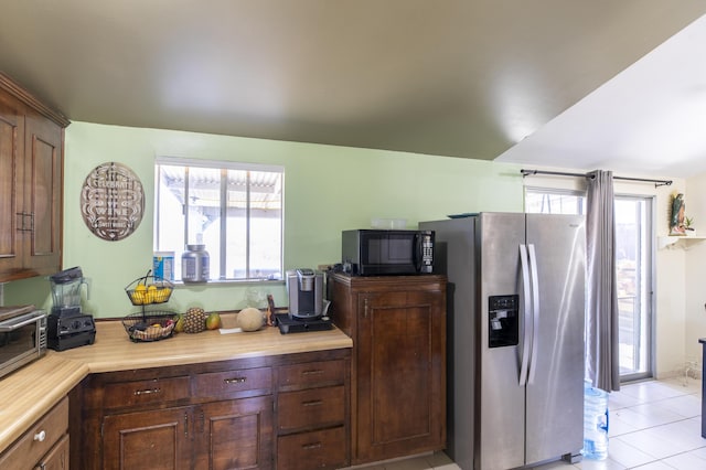 3608 Via Orilla, Lompoc, CA 93436 - kitchen with stainless steel refrigerator with ice dispenser, black microwave, light countertops, and light tile patterned floors