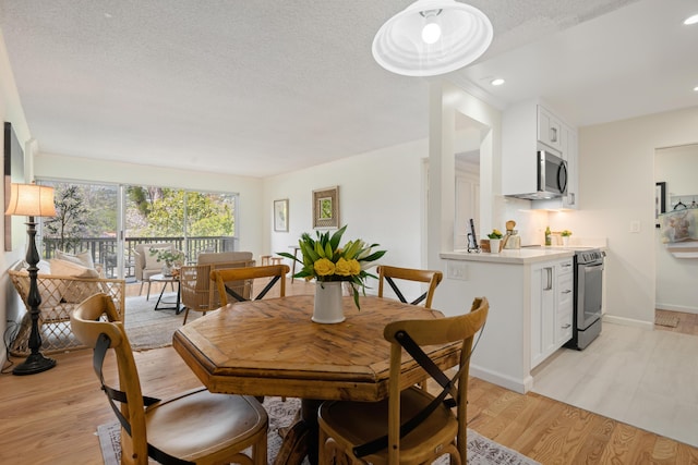 2727 Miradero Dr Unit 209, Santa Barbara, CA 93105 - dining room featuring light wood finished floors, recessed lighting, and a textured ceiling