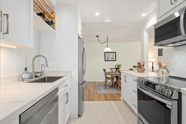 2727 Miradero Dr Unit 209, Santa Barbara, CA 93105 - kitchen with stainless steel appliances, white cabinets, decorative light fixtures, recessed lighting, and light stone countertops