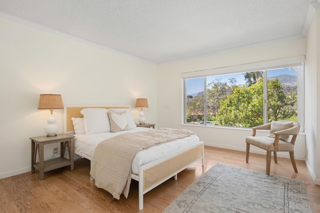 2727 Miradero Dr Unit 209, Santa Barbara, CA 93105 - bedroom featuring crown molding, wood finished floors, and a textured ceiling