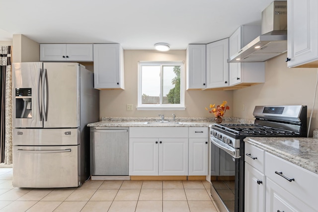 622 Colfax Ct, Goleta, CA 93117 - kitchen with stainless steel appliances, wall chimney range hood, white cabinets, light tile patterned flooring, and light stone countertops