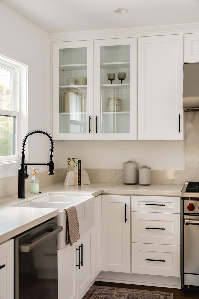 251 Cloydon Cir, Montecito, CA 93108 - kitchen featuring dishwashing machine, stainless steel range with gas stovetop, white cabinets, and glass insert cabinets