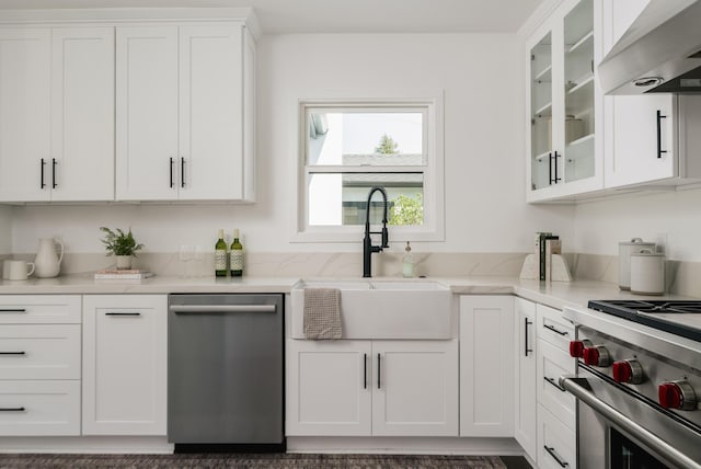 251 Cloydon Cir, Montecito, CA 93108 - kitchen featuring stainless steel dishwasher, exhaust hood, white cabinetry, light stone counters, and glass insert cabinets
