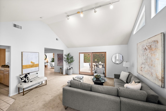 5668 Encina Rd, Goleta, CA 93117 - living area with high vaulted ceiling, track lighting, light colored carpet, and light tile patterned floors