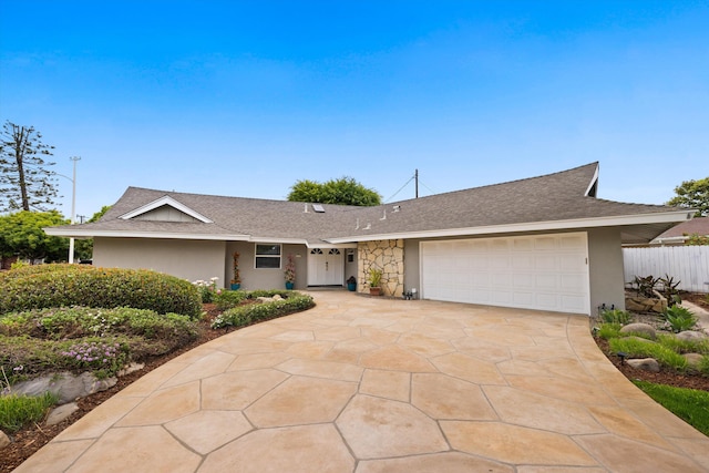 5668 Encina Rd, Goleta, CA 93117 - ranch-style home with a garage, roof with shingles, concrete driveway, and stucco siding