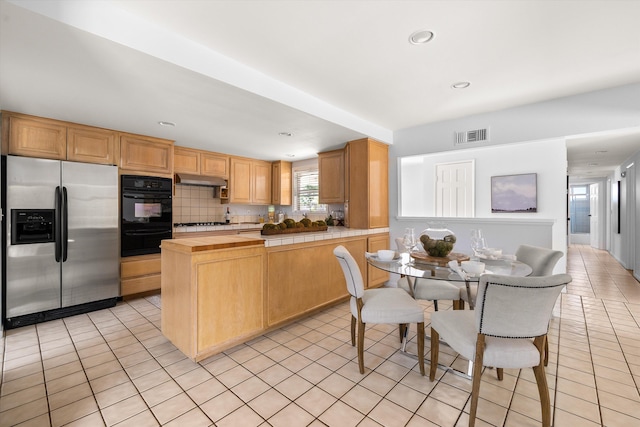 5668 Encina Rd, Goleta, CA 93117 - kitchen with stainless steel appliances, light tile patterned flooring, a warming drawer, decorative backsplash, and recessed lighting