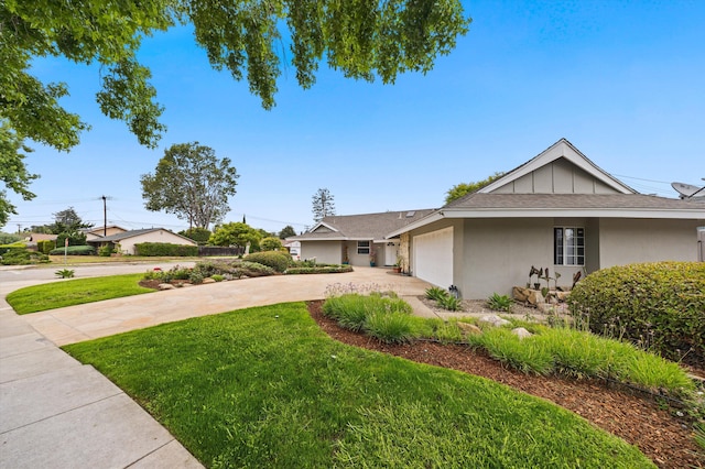 5668 Encina Rd, Goleta, CA 93117 - view of front of house featuring driveway, a front yard, stucco siding, a garage, and a shingled roof