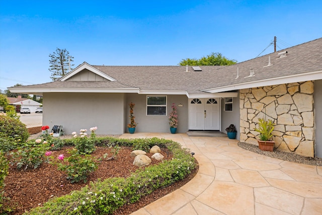 5668 Encina Rd, Goleta, CA 93117 - view of front of house featuring roof with shingles, stone siding, and stucco siding
