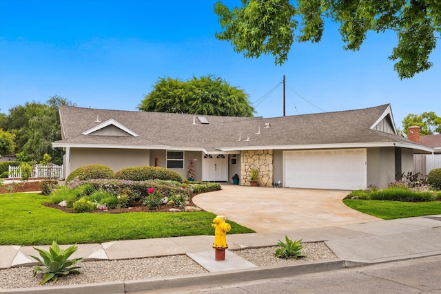5668 Encina Rd, Goleta, CA 93117 - ranch-style house with an attached garage, concrete driveway, a front yard, roof with shingles, and stucco siding