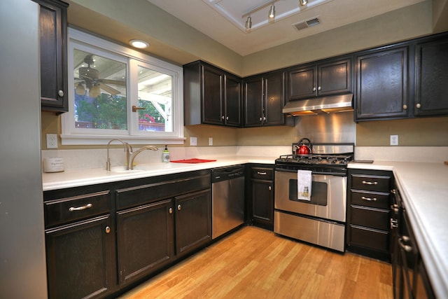 4014 Primavera Rd Unit A, Santa Barbara, CA 93110 - kitchen with appliances with stainless steel finishes, under cabinet range hood, light wood-style floors, light countertops, and track lighting