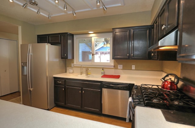 4014 Primavera Rd Unit A, Santa Barbara, CA 93110 - kitchen featuring stainless steel appliances, under cabinet range hood, light wood-style floors, and light countertops