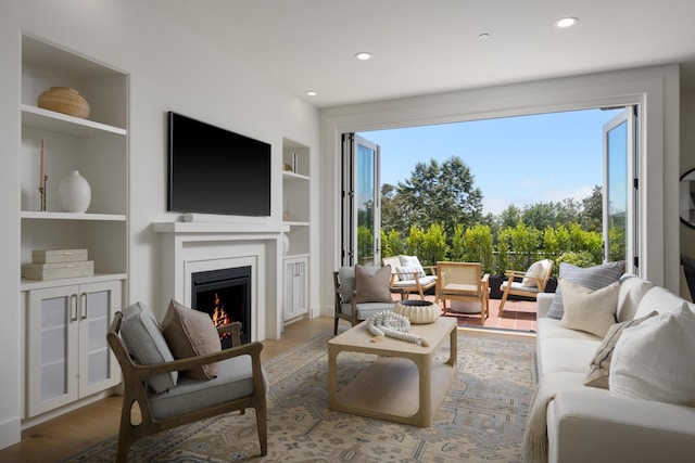 3718 State St Unit 314, Santa Barbara, CA 93105 - living room featuring built in features, a lit fireplace, healthy amount of natural light, wood finished floors, and recessed lighting