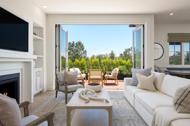 3718 State St Unit 314, Santa Barbara, CA 93105 - living area featuring a lit fireplace, recessed lighting, light wood-style floors, and built in shelves