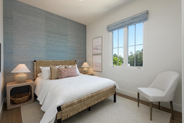 3718 State St Unit 314, Santa Barbara, CA 93105 - bedroom featuring an accent wall and wood finished floors