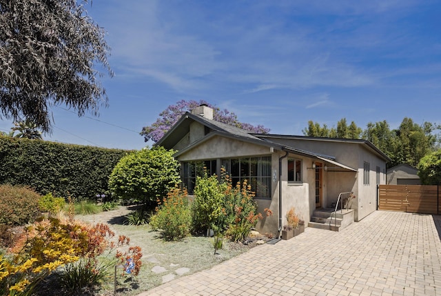 1138 Vallecito Rd, Carpinteria, CA 93013 - view of front of house with stucco siding and a chimney