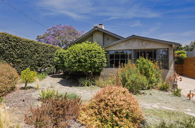 1138 Vallecito Rd, Carpinteria, CA 93013 - back of house featuring stucco siding and a chimney