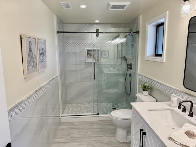 19 W Quinto St, Santa Barbara, CA 93105 - full bath featuring a shower stall, vanity, tile walls, a wainscoted wall, and recessed lighting