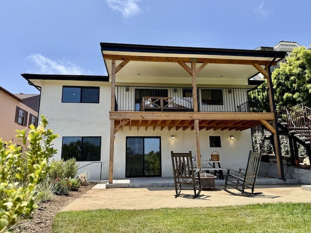 19 W Quinto St, Santa Barbara, CA 93105 - rear view of property with a balcony, a patio area, stucco siding, and stairs