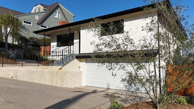 19 W Quinto St, Santa Barbara, CA 93105 - view of front of house featuring stucco siding, driveway, stairway, and a garage