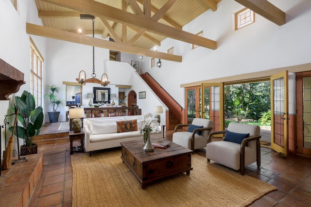 601 San Ysidro Rd, Santa Barbara, CA 93108 - living area with high vaulted ceiling, a chandelier, a wooden ceiling with exposed beams, and french doors