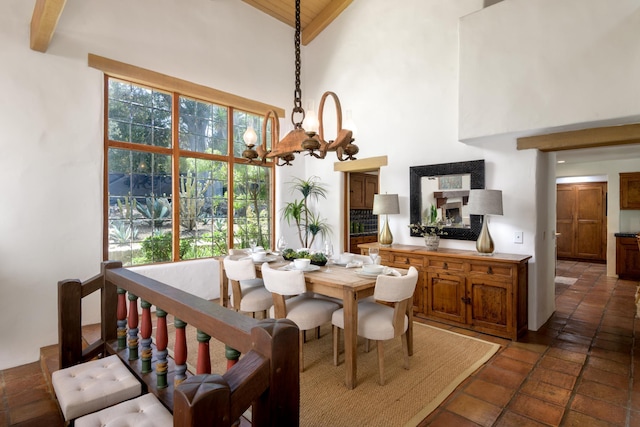 601 San Ysidro Rd, Santa Barbara, CA 93108 - dining area featuring high vaulted ceiling, a chandelier, healthy amount of natural light, and a wooden ceiling with exposed beams