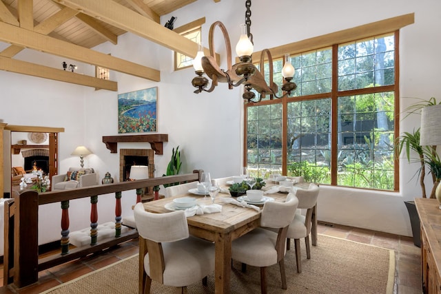 601 San Ysidro Rd, Santa Barbara, CA 93108 - dining space featuring a fireplace, a wood ceiling with exposed beams, stone tile flooring, plenty of natural light, and a chandelier