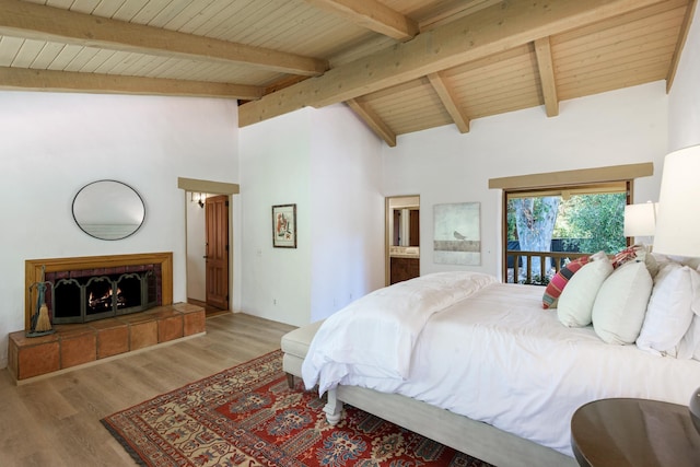 601 San Ysidro Rd, Santa Barbara, CA 93108 - bedroom featuring wood finished floors, a wooden ceiling with exposed beams, high vaulted ceiling, a tiled fireplace, and access to outside