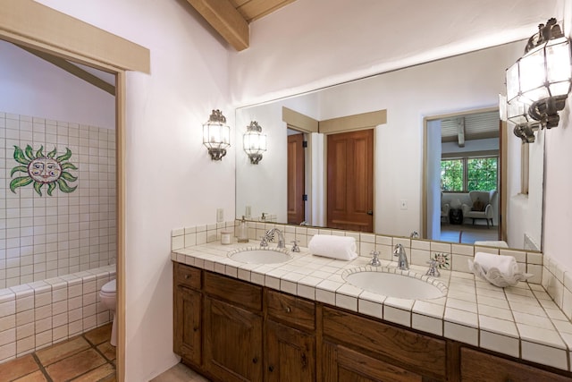 601 San Ysidro Rd, Santa Barbara, CA 93108 - ensuite bathroom featuring double vanity, a tile shower, beam ceiling, and tile patterned flooring