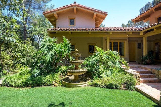 601 San Ysidro Rd, Santa Barbara, CA 93108 - back of property featuring a tiled roof, a lawn, and stucco siding