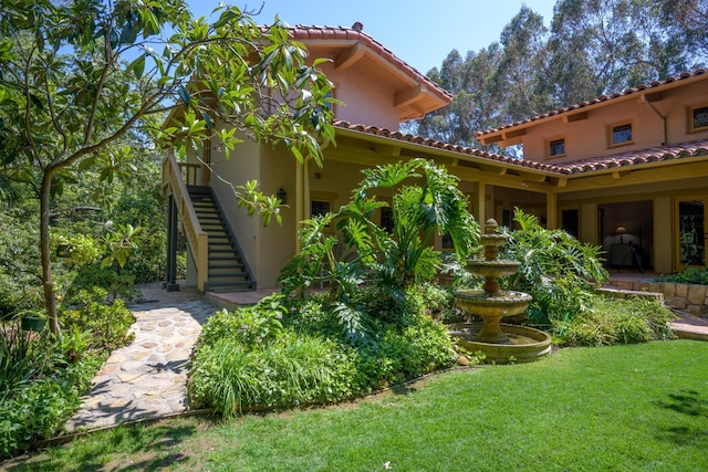 601 San Ysidro Rd, Santa Barbara, CA 93108 - back of property with stairway, stucco siding, a lawn, and a tile roof