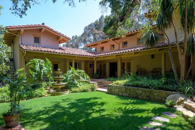 601 San Ysidro Rd, Santa Barbara, CA 93108 - back of property with stucco siding, a lawn, and a tile roof