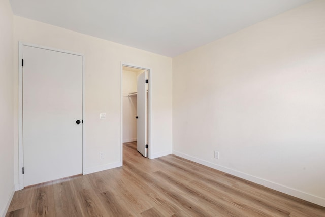 5925 Birch St Unit 4, Carpinteria, CA 93013 - unfurnished bedroom featuring light wood-style flooring and a walk in closet