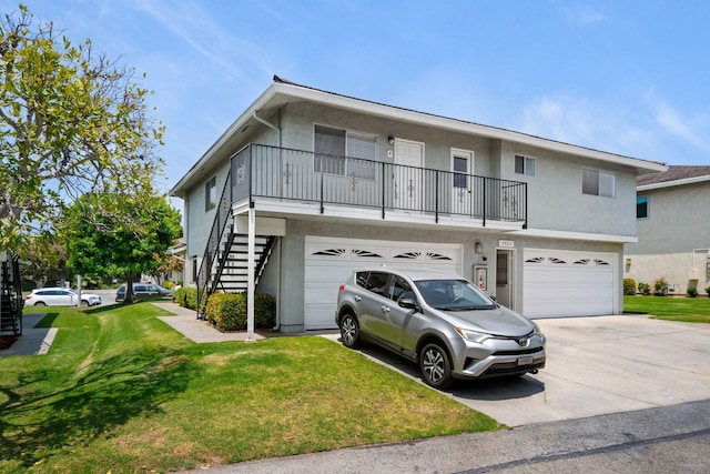 5925 Birch St Unit 4, Carpinteria, CA 93013 - view of front of home with an attached garage, stucco siding, stairs, and a front lawn
