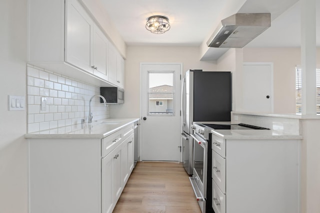 5925 Birch St Unit 4, Carpinteria, CA 93013 - kitchen with stainless steel appliances, plenty of natural light, exhaust hood, and backsplash