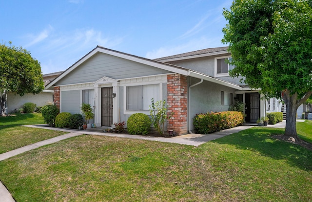 5925 Birch St Unit 4, Carpinteria, CA 93013 - view of front of property with a front yard, stucco siding, and brick siding