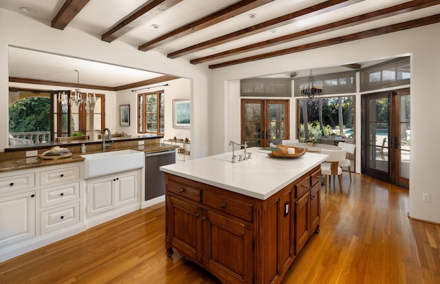 771 Via Manana, Montecito, CA 93108 - kitchen featuring a chandelier, stainless steel dishwasher, brown cabinetry, light wood finished floors, and french doors