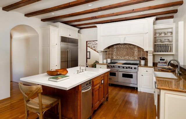 771 Via Manana, Montecito, CA 93108 - kitchen with high end appliances, beam ceiling, tasteful backsplash, dark wood-style floors, and white cabinetry