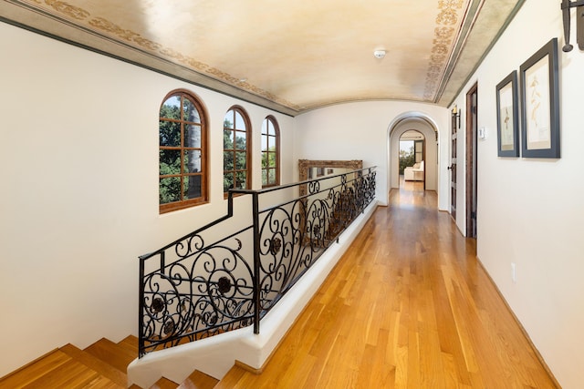 771 Via Manana, Montecito, CA 93108 - hall with arched walkways, light wood-style flooring, vaulted ceiling, and an upstairs landing