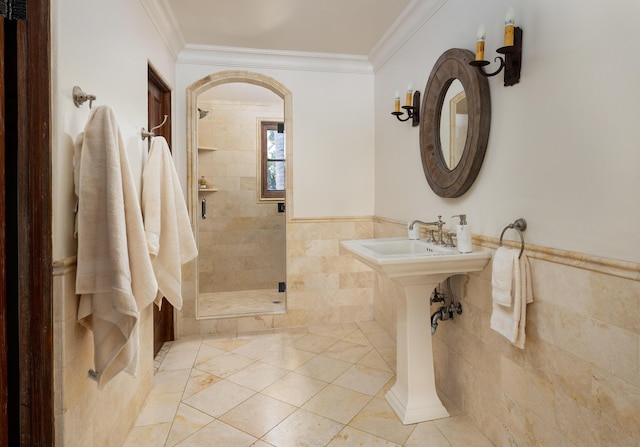 771 Via Manana, Montecito, CA 93108 - bathroom featuring tile walls, a stall shower, crown molding, tile patterned floors, and wainscoting