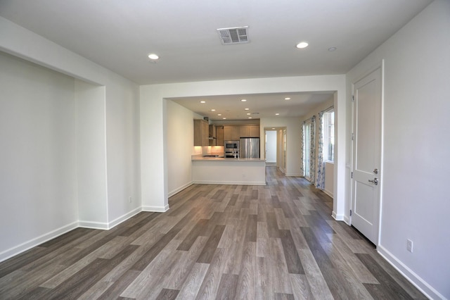 6628 Sand Castle Pl Unit C-7, Goleta, CA 93117 - unfurnished living room with dark wood-style flooring and recessed lighting