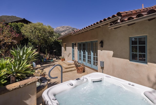 1439 Tunnel Rd, Santa Barbara, CA 93105 - view of patio / terrace featuring a mountain view, a hot tub, and french doors