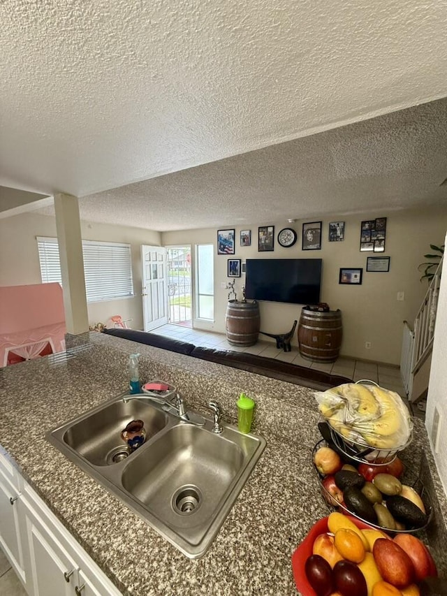 701 Halyard St, Port Hueneme, CA 93041 - kitchen view of a textured ceiling, dark countertops, and white cabinets