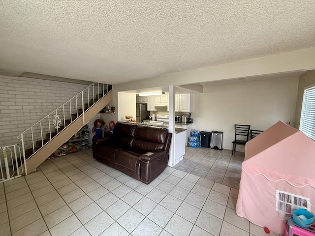 701 Halyard St, Port Hueneme, CA 93041 - living area with stairs, a textured ceiling, light tile patterned floors, and brick wall