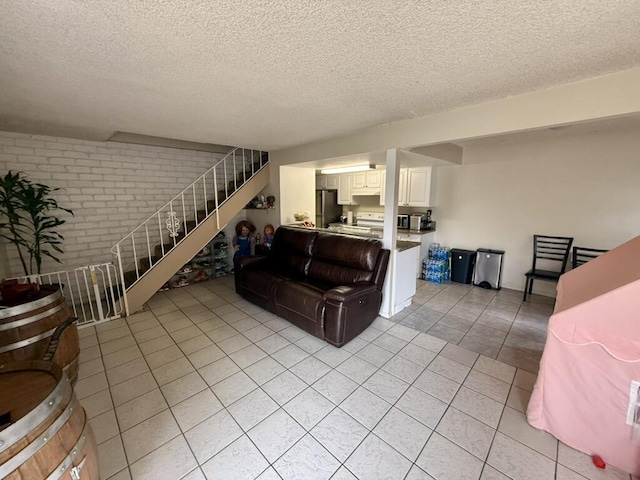 701 Halyard St, Port Hueneme, CA 93041 - living room featuring light tile patterned floors, stairway, a textured ceiling, and brick wall