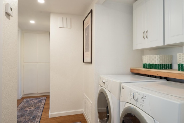 521 W Montecito St Unit 4, Santa Barbara, CA 93101 - washroom with washing machine and clothes dryer, light wood-style flooring, recessed lighting, and cabinet space
