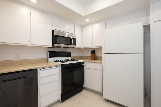 521 W Montecito St Unit 4, Santa Barbara, CA 93101 - kitchen featuring freestanding refrigerator, dishwashing machine, stainless steel microwave, black range with gas stovetop, and light countertops