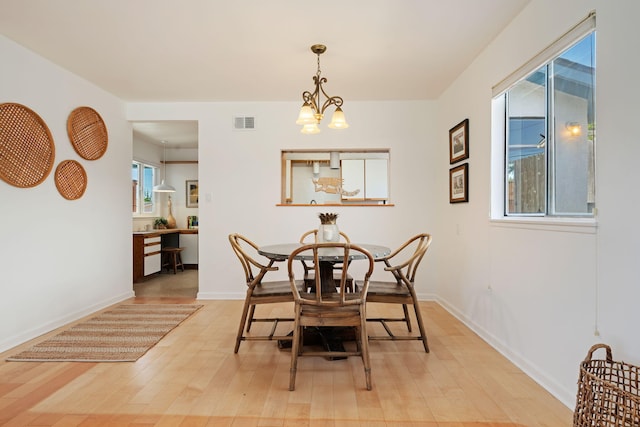 7234 Del Norte Dr, Goleta, CA 93117 - dining room with light wood-style floors and a chandelier