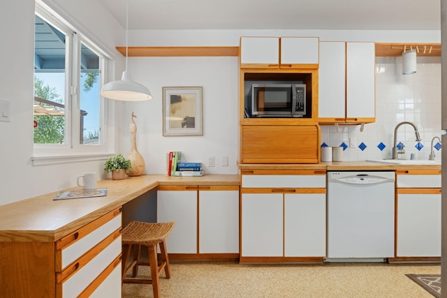7234 Del Norte Dr, Goleta, CA 93117 - kitchen featuring white dishwasher, stainless steel microwave, white cabinetry, light countertops, and decorative backsplash